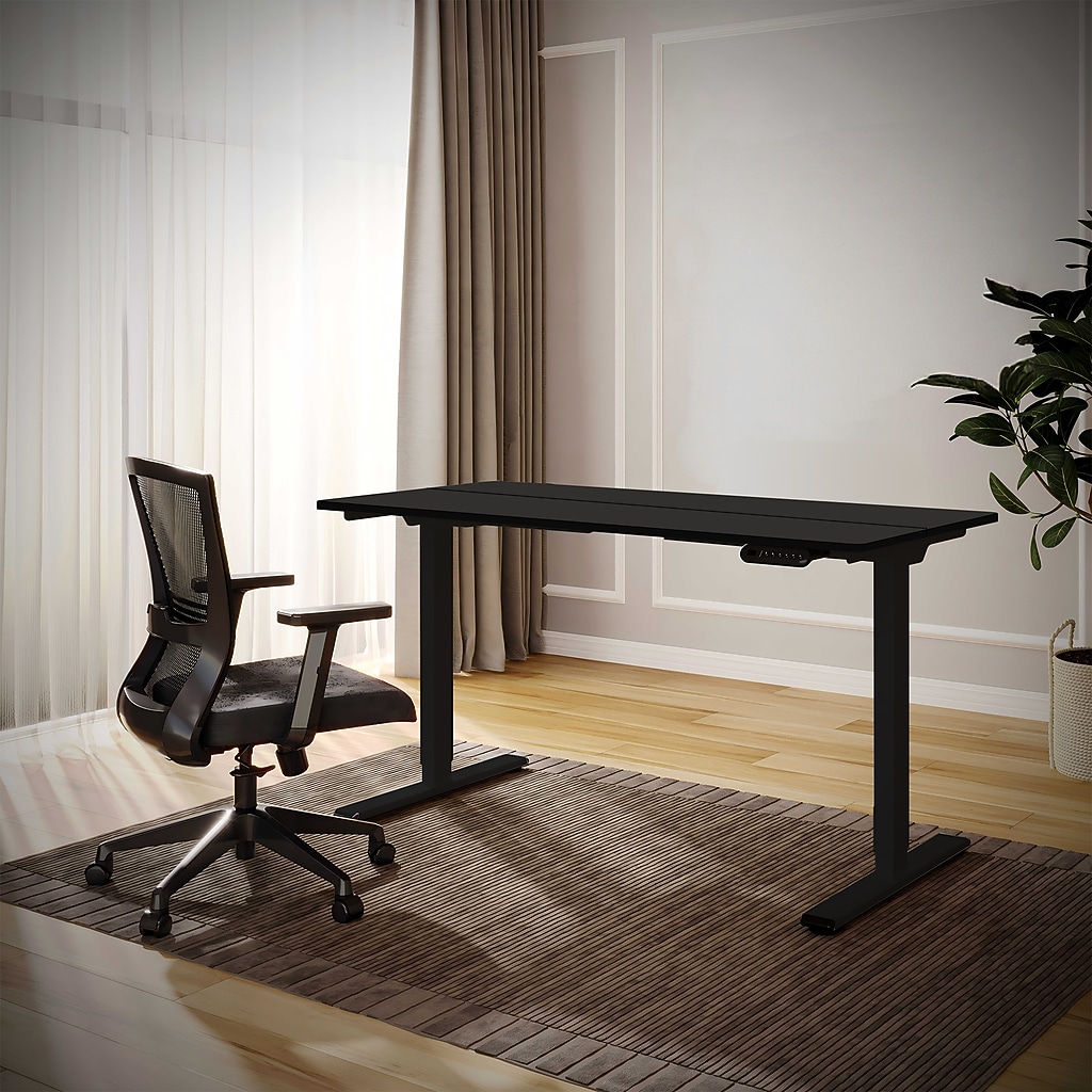 Desk in a home office with chair and sunlit curtains