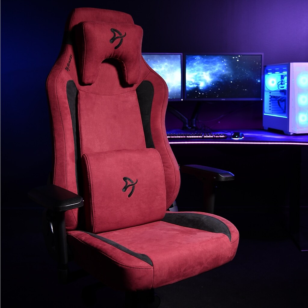Red ergonomic racing gaming chair in front of computer setup