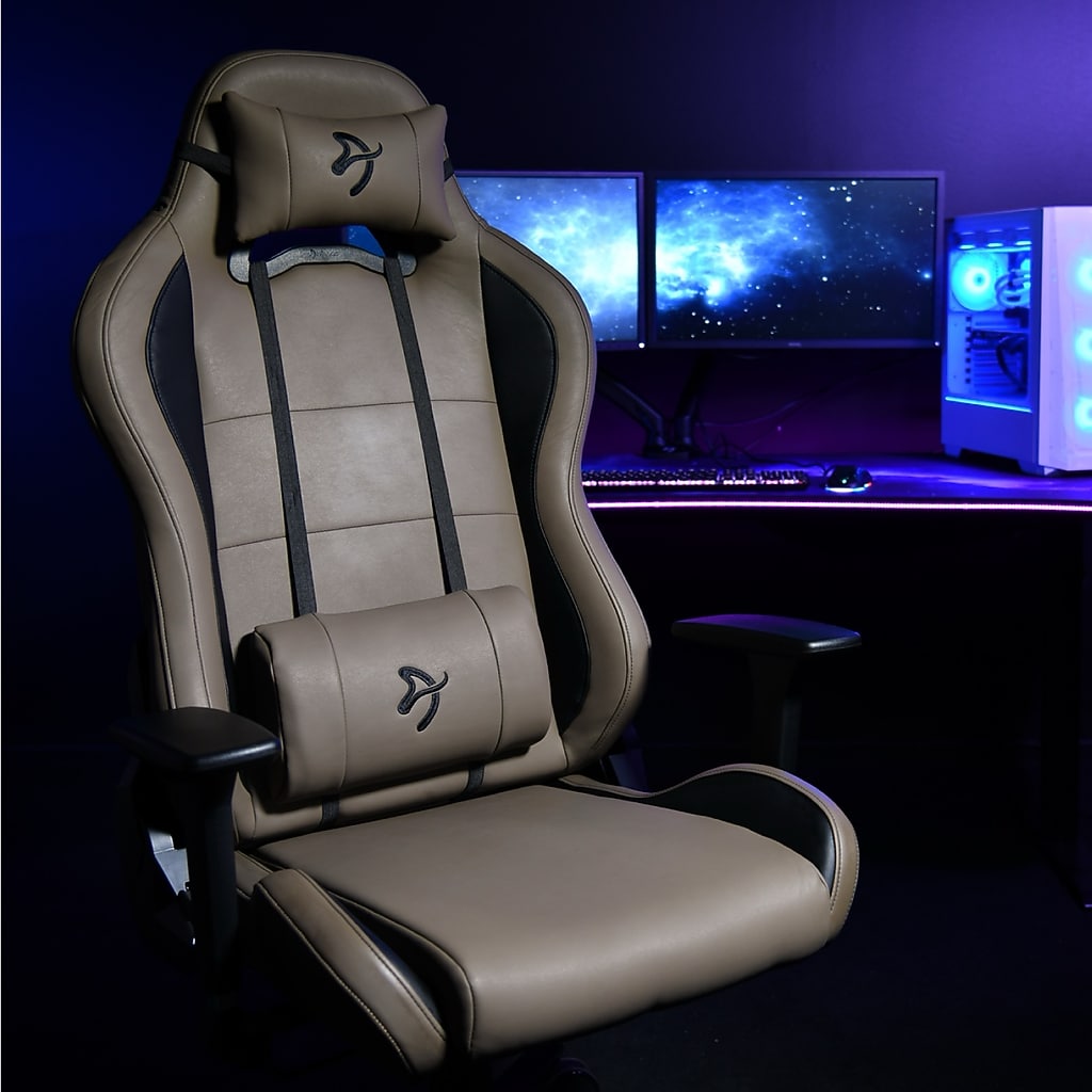 Close-up of brown Arozzi Torretta chair with gaming setup in background.