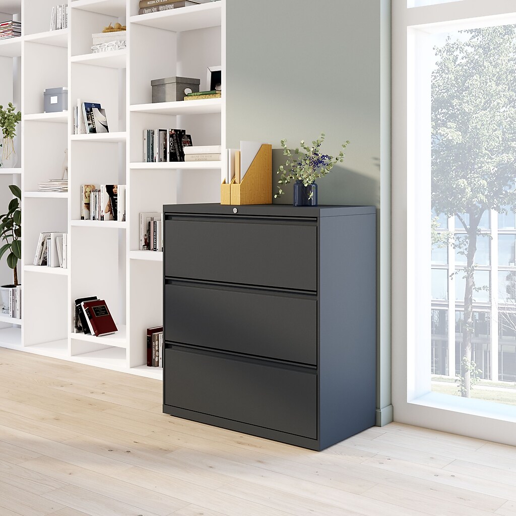 3-drawer cabinet beside white bookcase