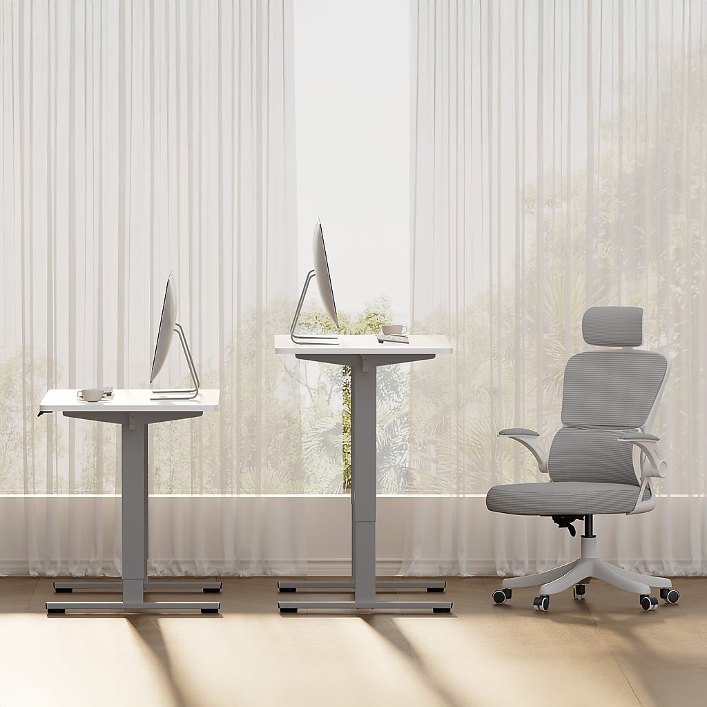 Two desks and an ergonomic chair in a bright office
