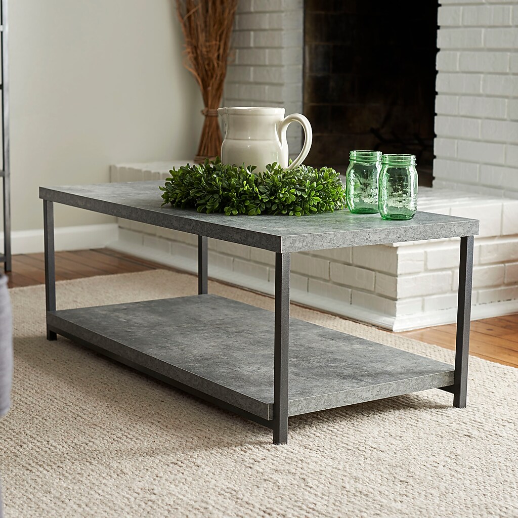 Coffee table placed in living room with decor items on top
