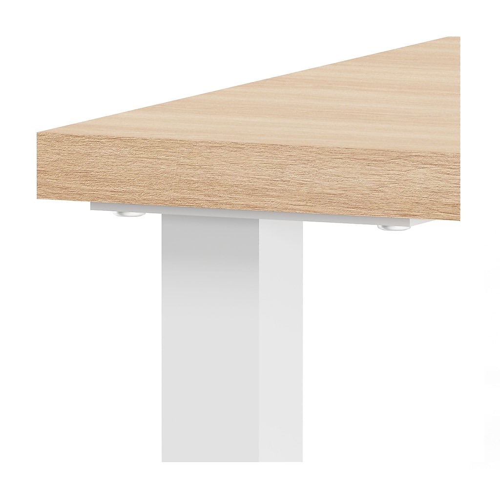 Close-up of desk legs and work surface edge showing light wood top and white metal legs
