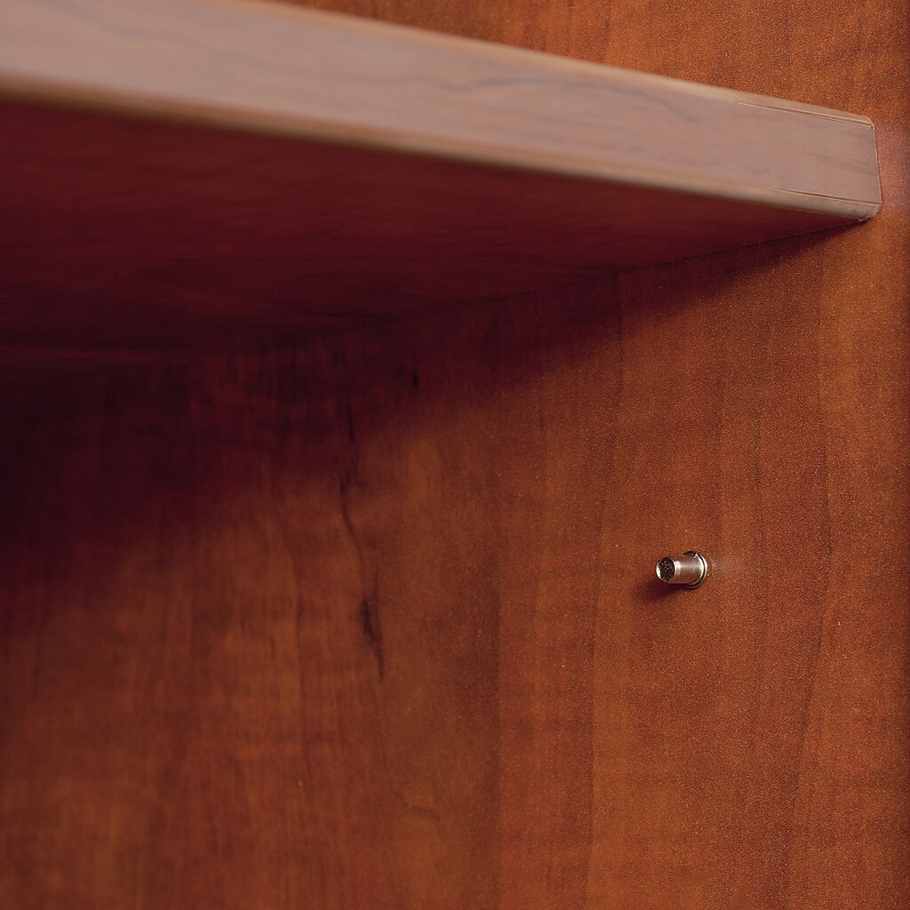 Close-up of shelf edge and small metal screw/peg