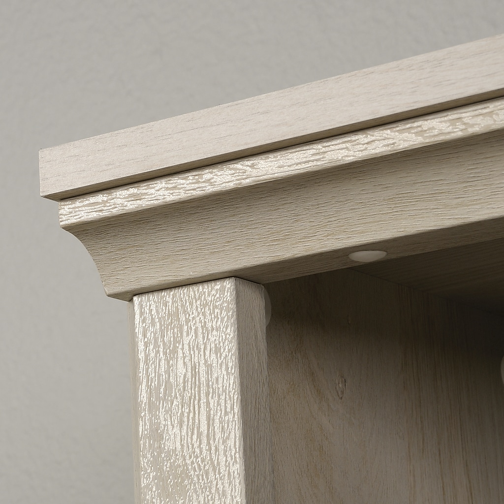 Close-up of bookcase corner showing wood grain and molding