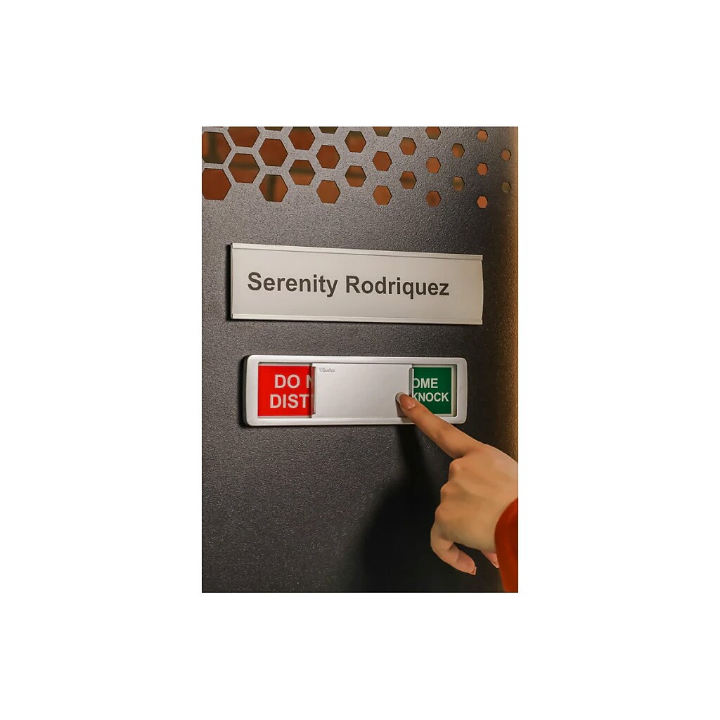 Close-up of nameplate and a person pressing a door/dummy switch labeled for a cubicle