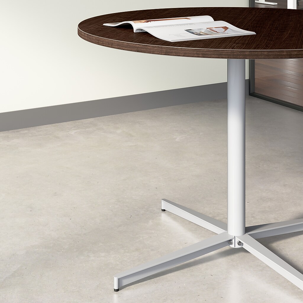 Close-up of round table edge and pedestal base
