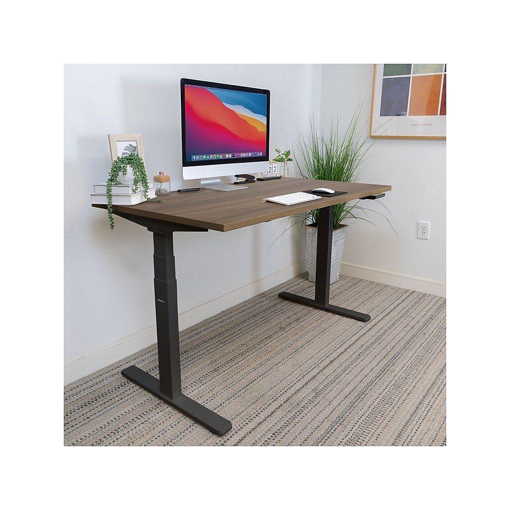 Desk in home office setup with computer monitor and keyboard.