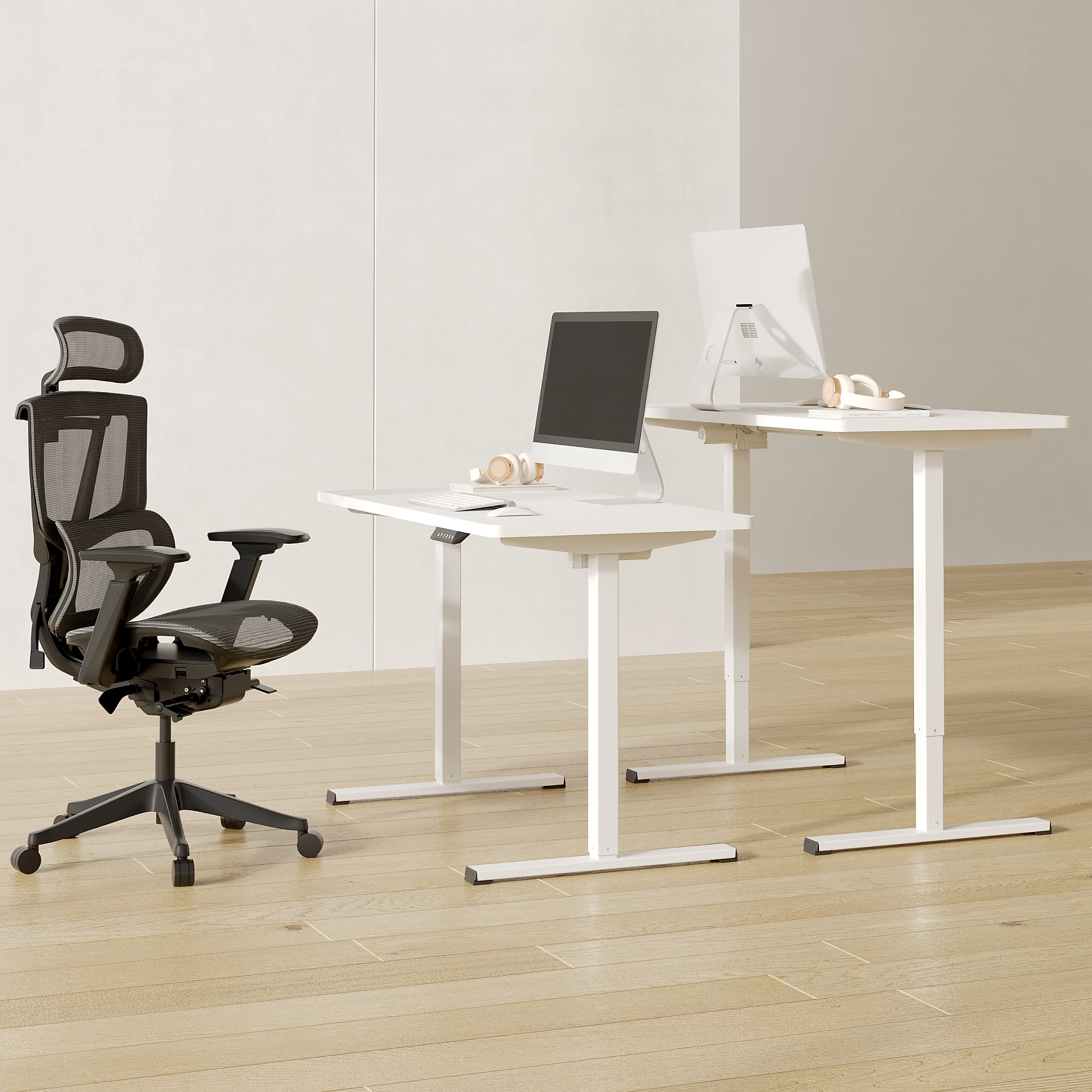 White electric adjustable standing desk with monitors and keyboard