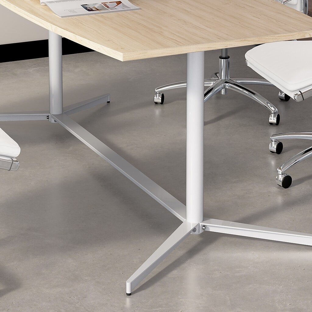 Close-up of conference table legs and base with wheels on chairs nearby