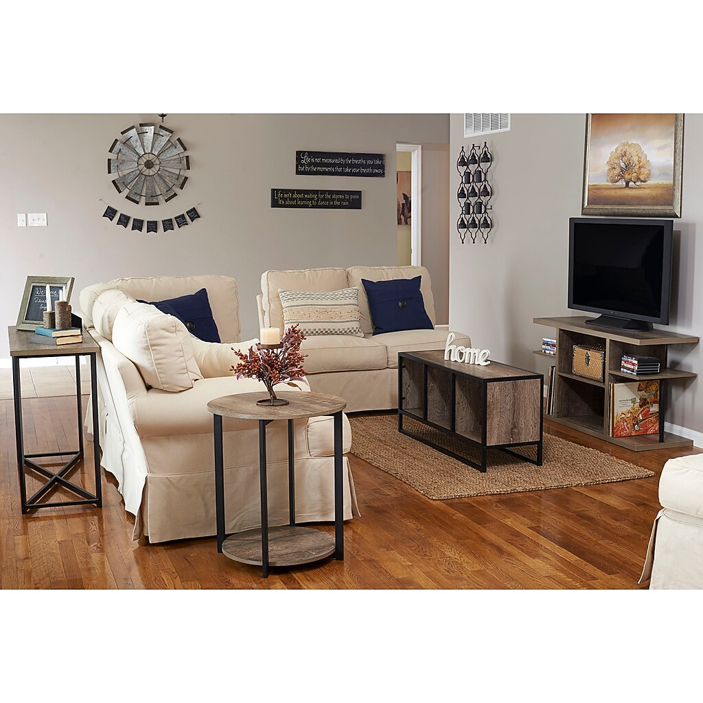 Round end table in a living room with sofa and decor