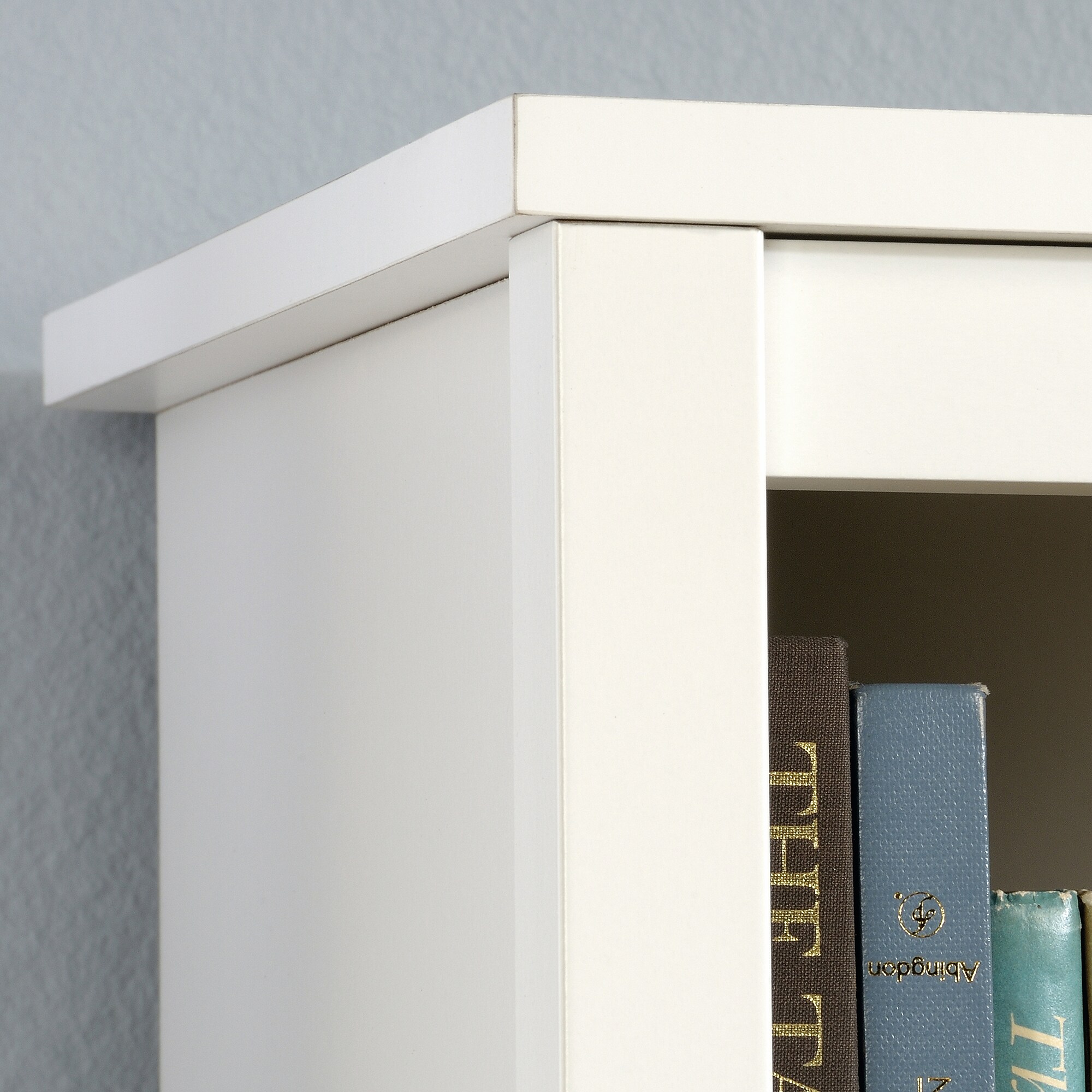 Close-up of soft white bookcase shelving side and top edge