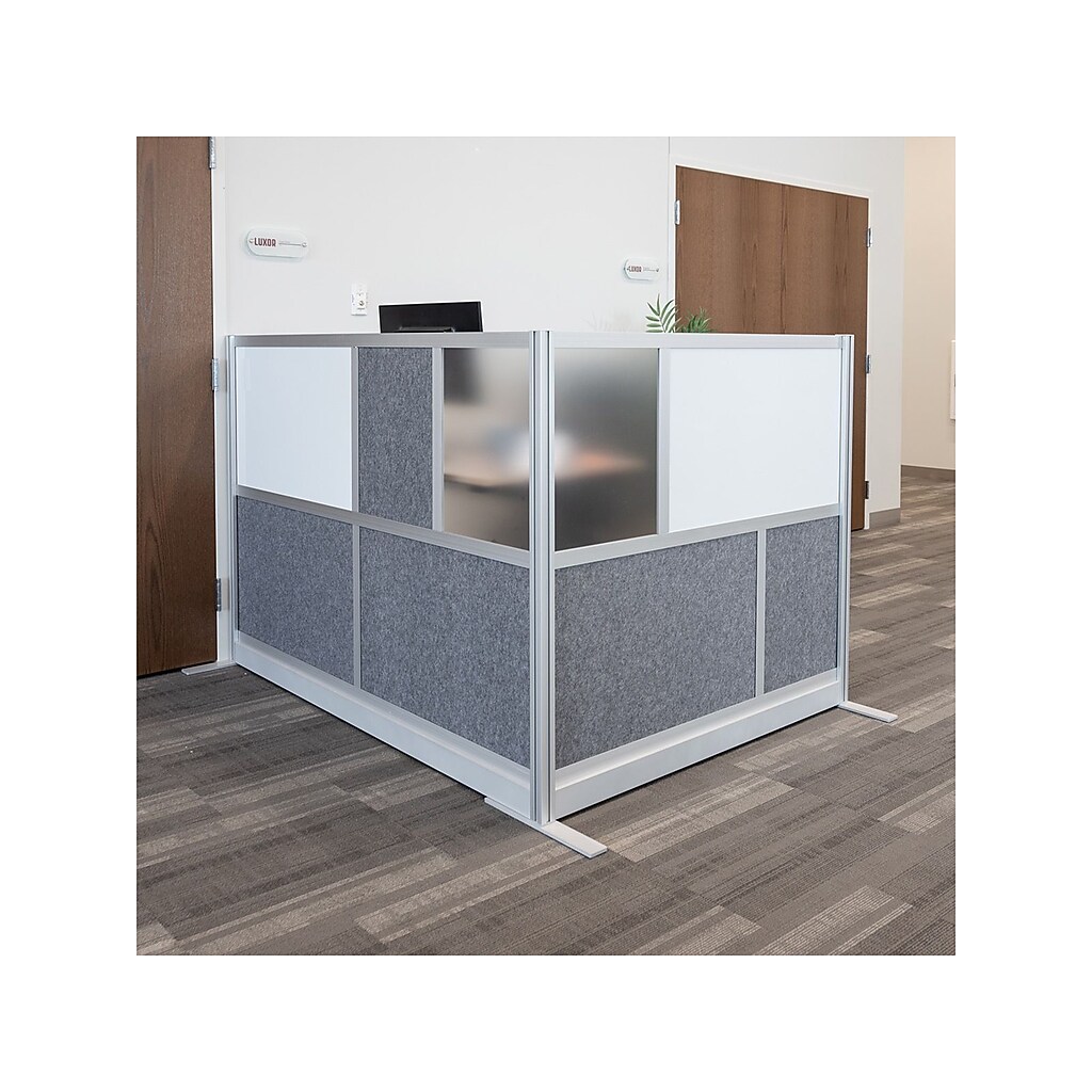 Office cubicle partition with fabric panels and power strip nearby