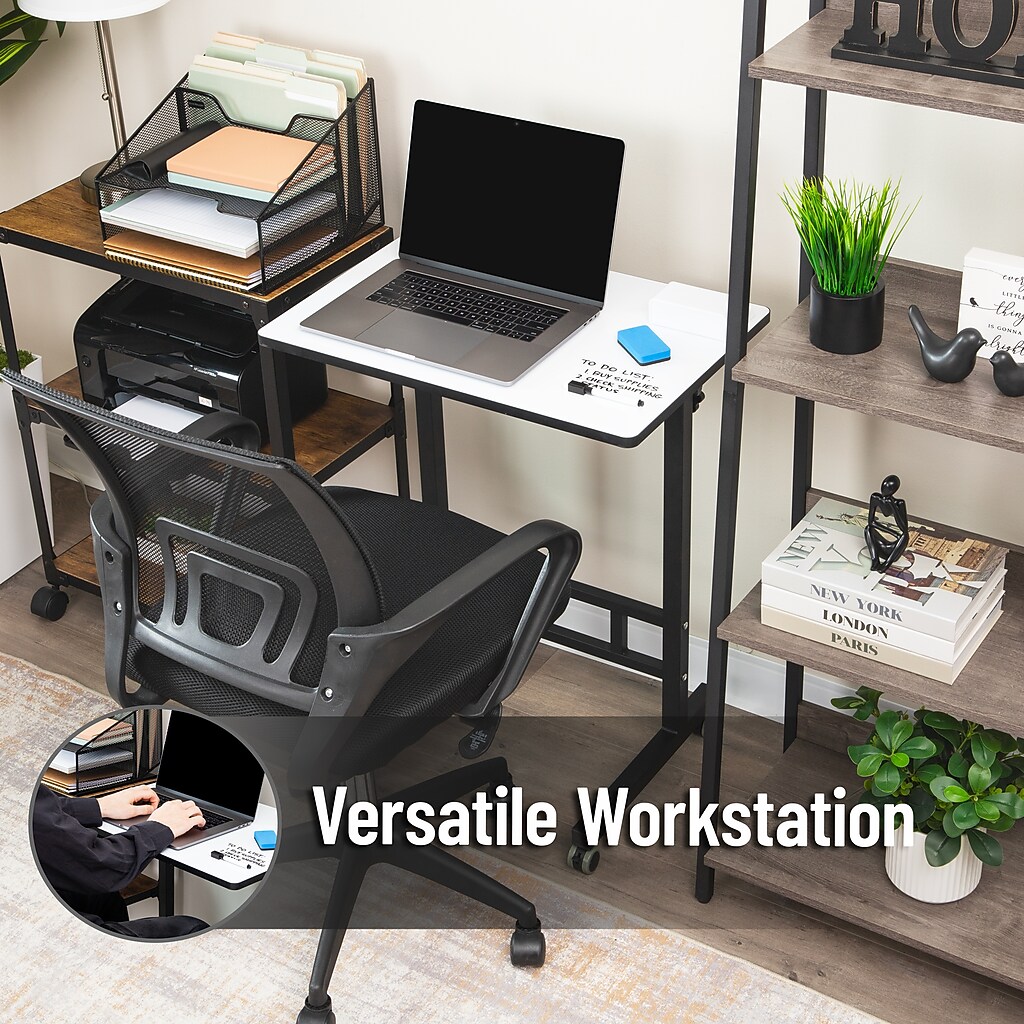 Whiteboard desk with laptop and accessories in an office setup