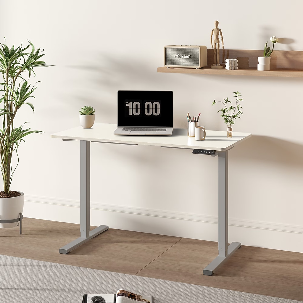 Desk in a modern home office setup with laptop on desk