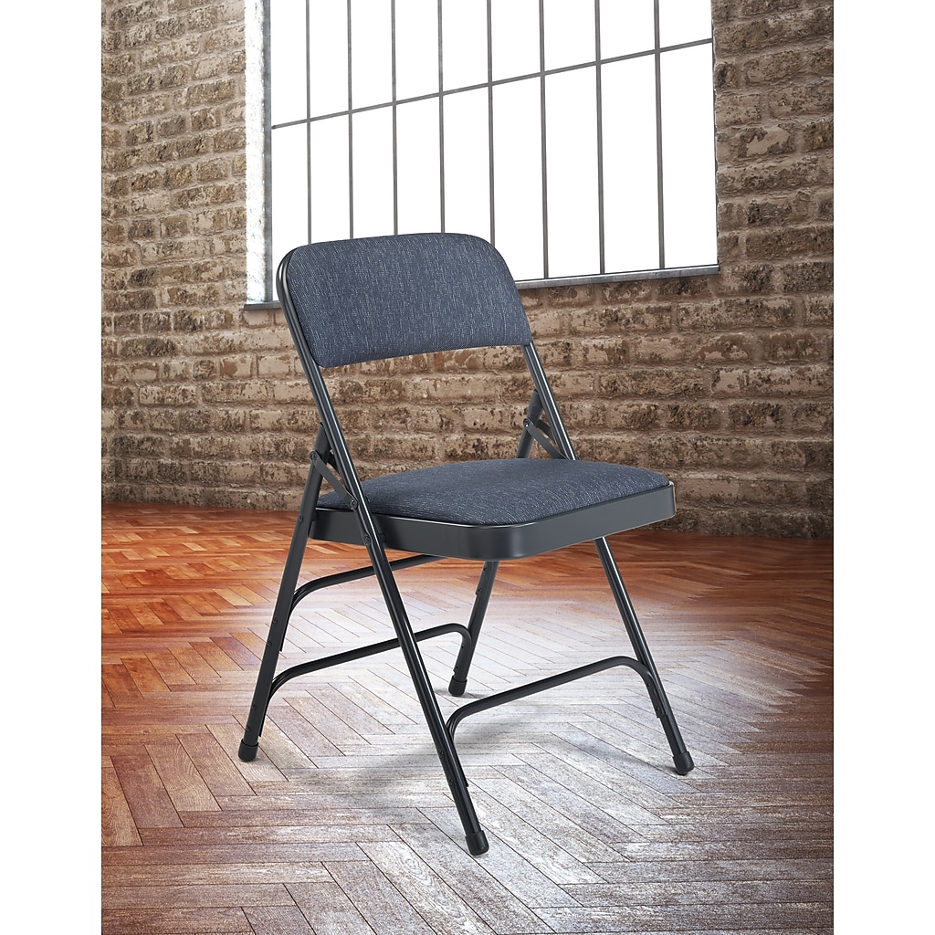 Folding chair in a room with brick wall and wooden floor