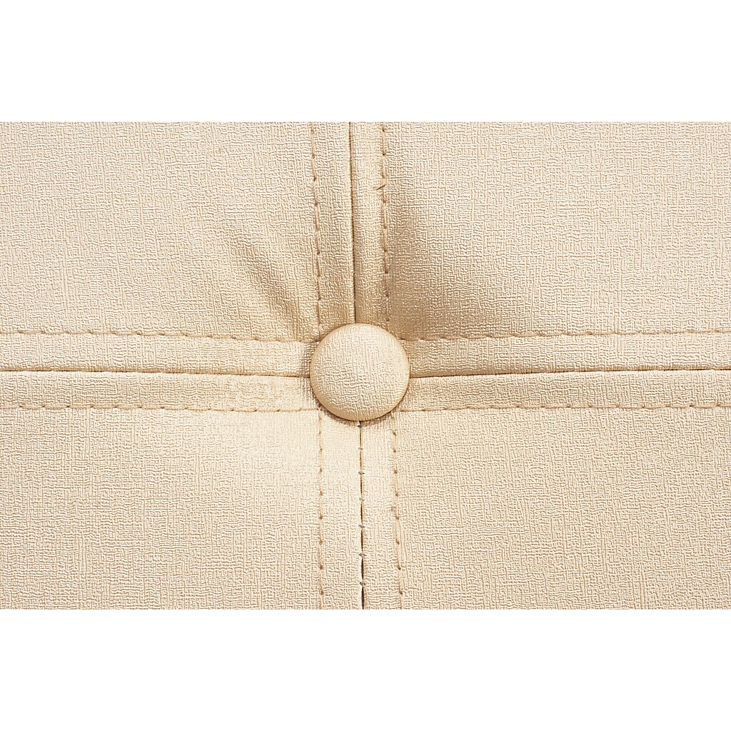 Close-up of beige faux leather stitching with button-tufted detail