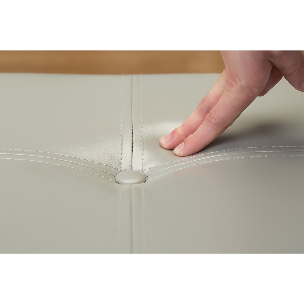 Close-up of stud-like fastener and stitching on ottoman