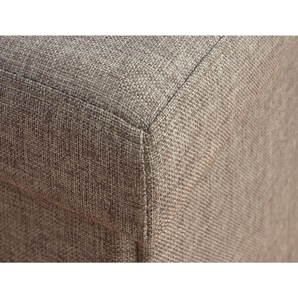 Corner seam of grey upholstered storage ottoman
