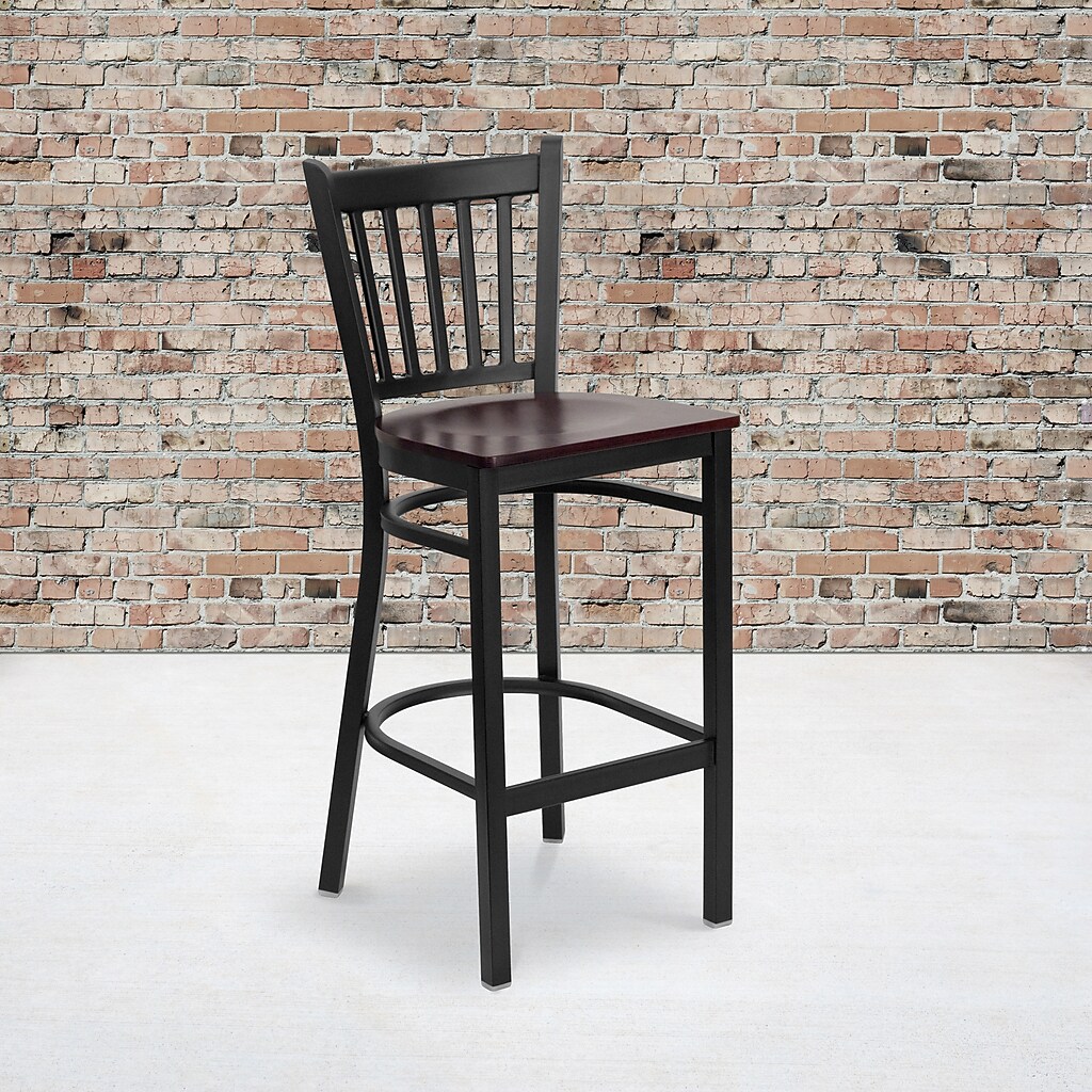 Bar stool against brick background, black metal frame and mahogany seat